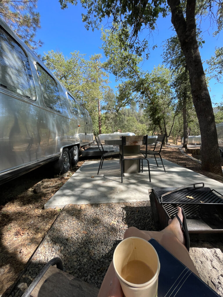 Drinking coffee outside an airstream at Autocamp Yosemite
