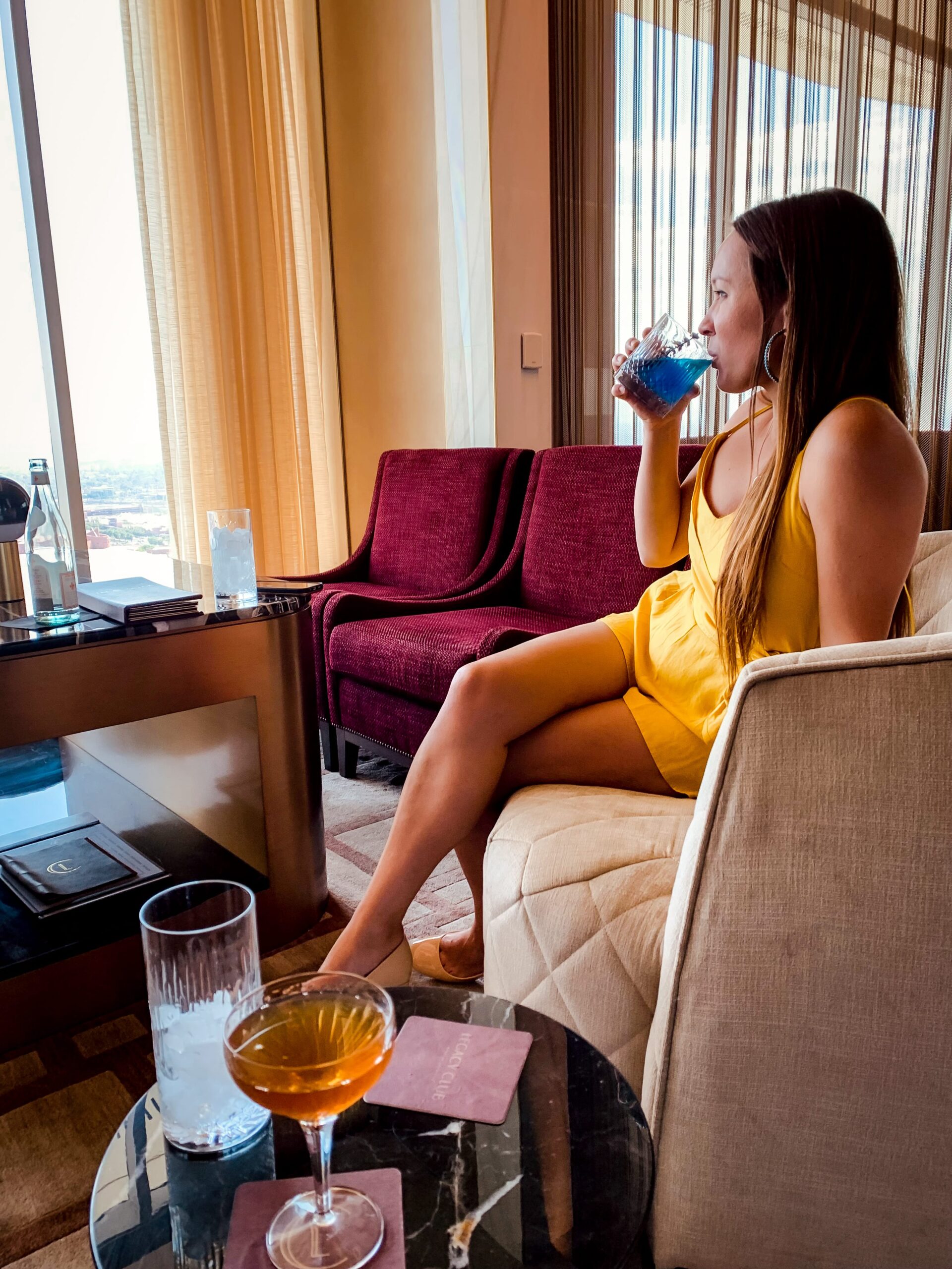 Girl sipping cocktail at Legacy Club Las Vegas with a view of the strip