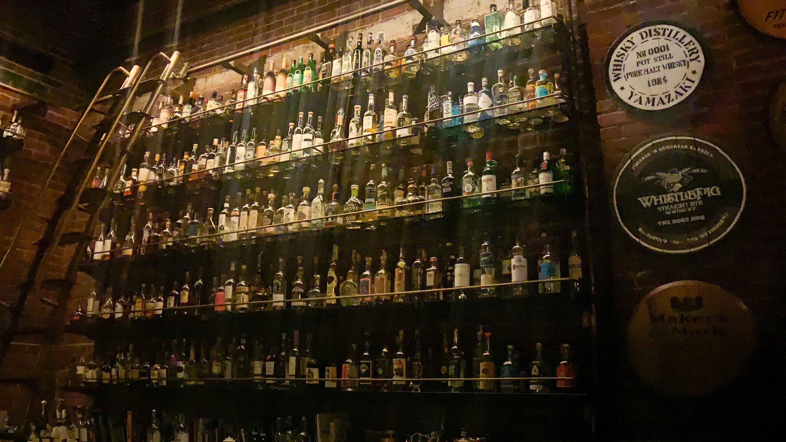 Row of Whiskeys Behind the Bar at Multnomah Whiskey Library in Portland