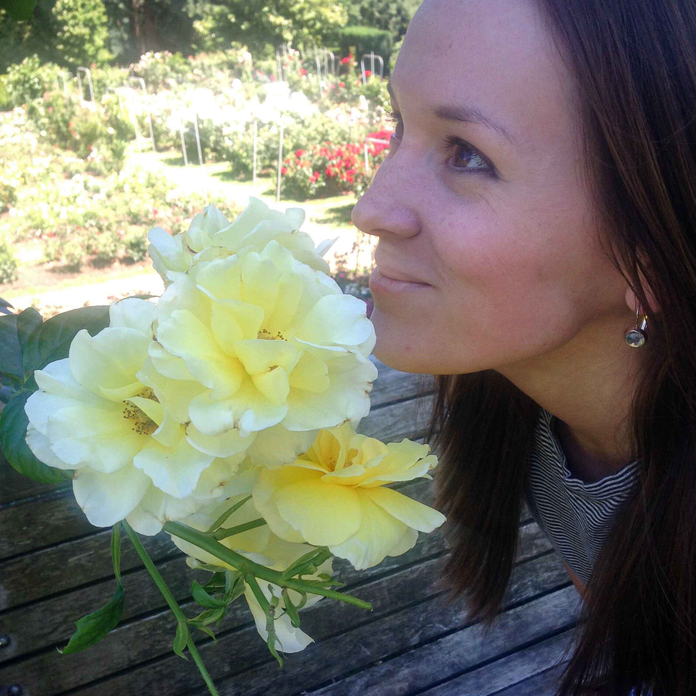 Girl Smelling Yellow Roses at Portland Rose Test Garden