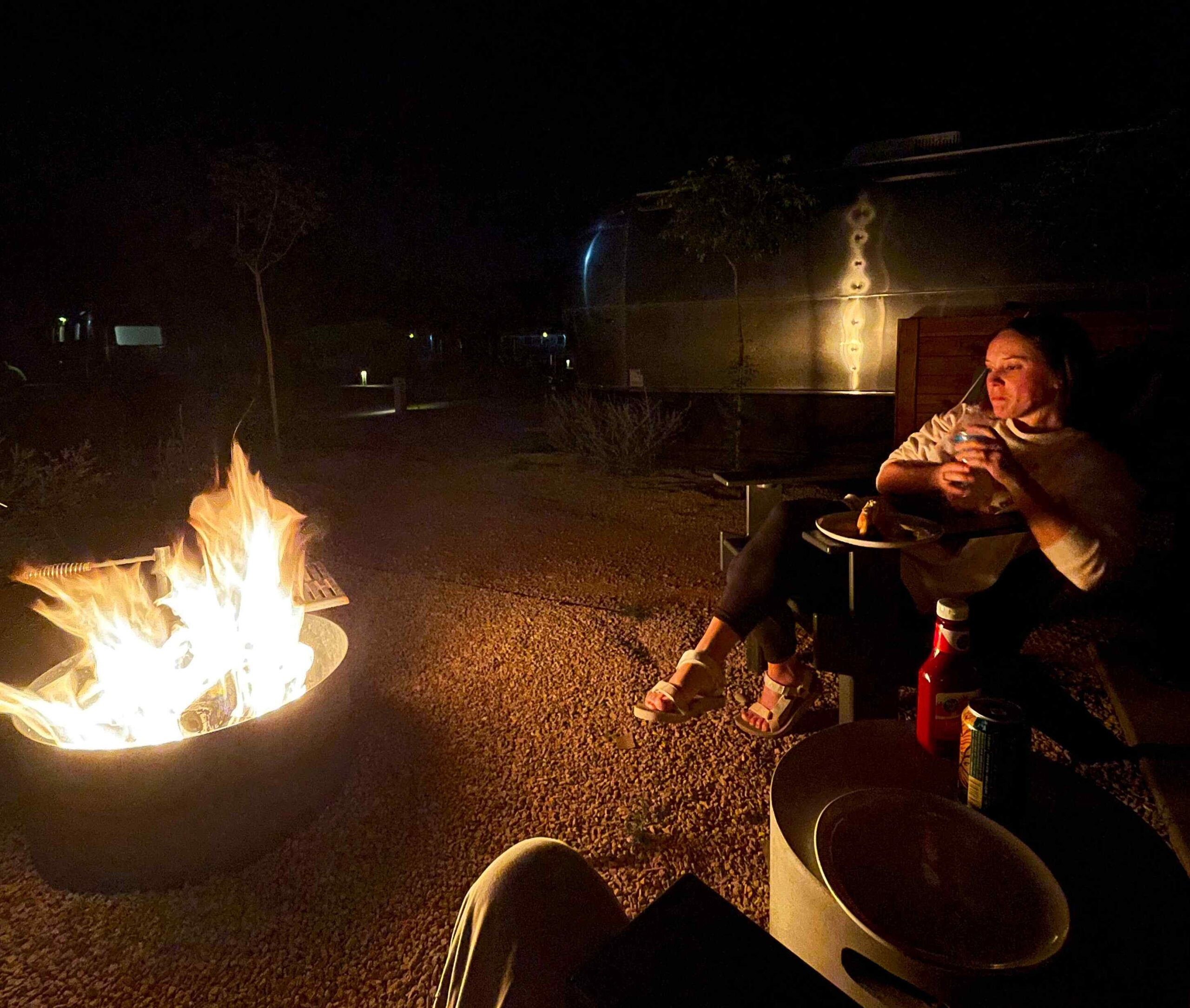 Girl sitting near a camp fire