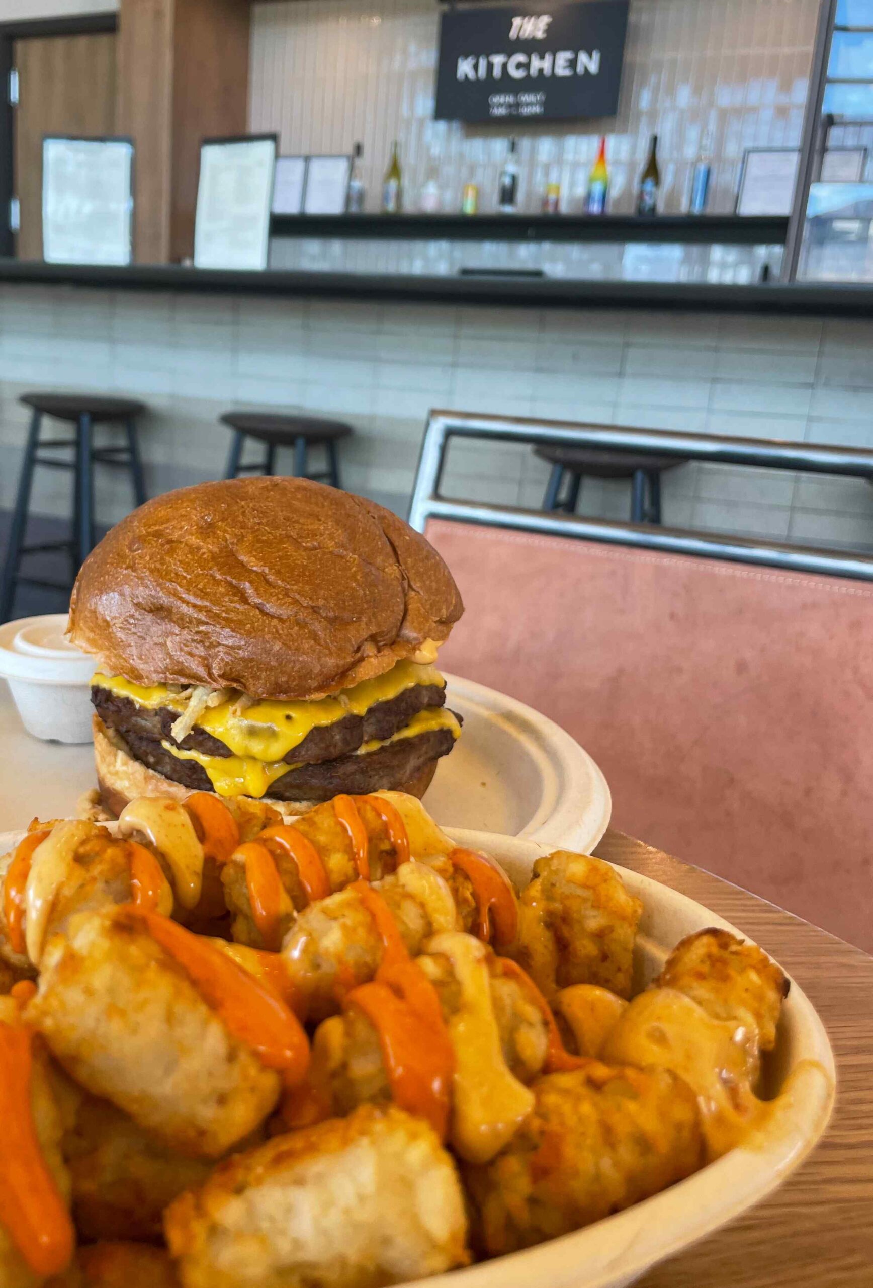 Burger with tots from The Kitchen at Autocamp restaurants