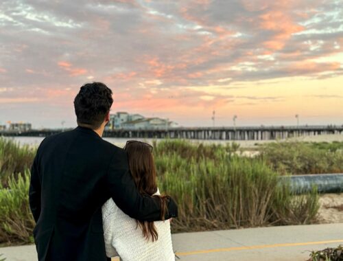 man and woman in front of sunset on the pier in Santa Barbara